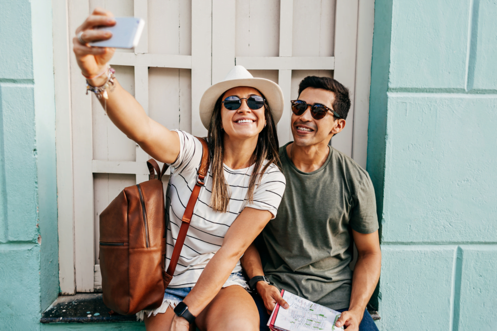Travelers smiling and taking a snap shot selfie.